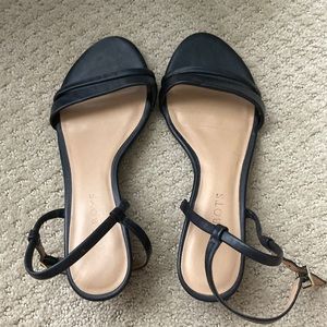 Women’s black sandals with a small wedge heel